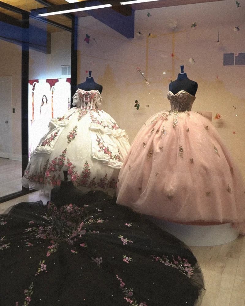 Dresses in front of a flower wall